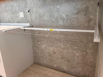 Wall-mounted clothesline, space-saving and weather-resistant.